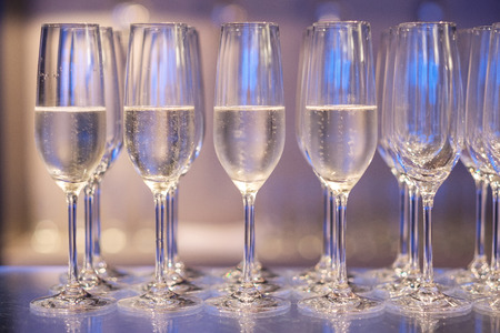 White wine in glasses on bar ready to drink.の写真素材
