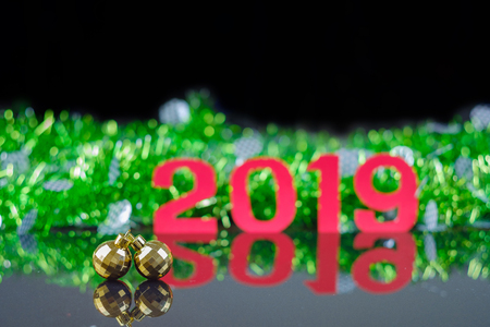Closeup double golden circle ornaments on reflex floor with background of new year 2019.の写真素材