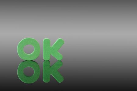 Word of OK and shadow reflect on grayの写真素材