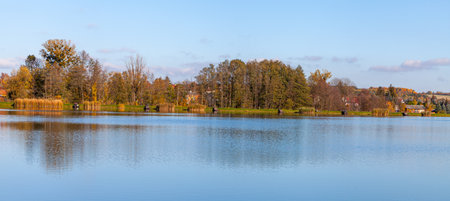 Landscape in the countryside by the lake on a sunny October day. A quiet place to relax by the water.の写真素材
