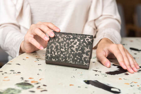 Purse in the hands of a girl in whiteの写真素材