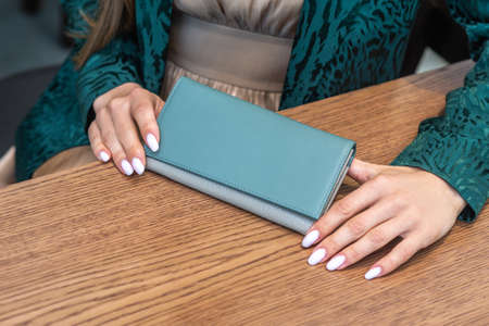 The girl has a wallet on the wood tableの写真素材