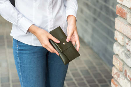 A girl holding a purse in her handの写真素材