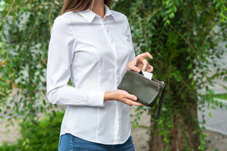 A girl holding a purse in her handの写真素材