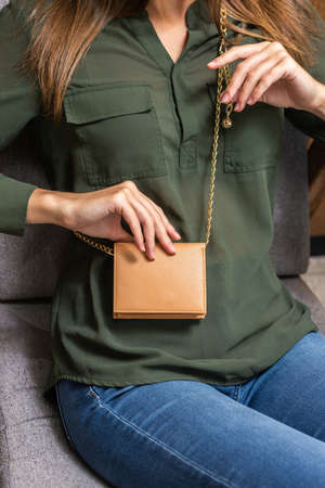 Beautiful purse bag on a girl in greenの写真素材