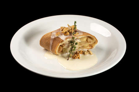Delicious strudel with condensed milk on a white plateの写真素材