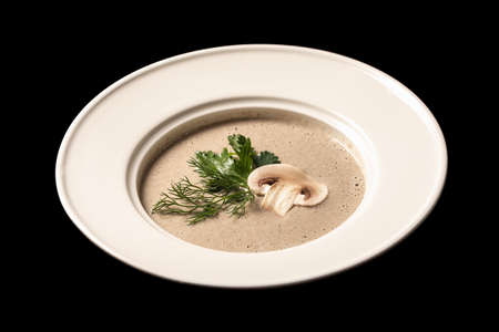 Vegetarian mushroom soup with dill in a white plateの写真素材