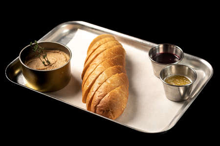 Bread with pate on a tray, black backgroundの写真素材