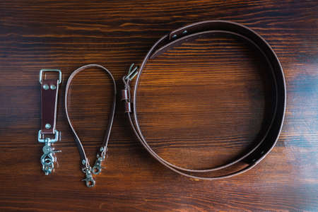 Stylish handmade leather belt on wooden background for mens fashionの写真素材