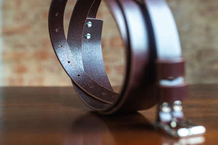 Stylish leather belt on wooden background for mens fashionの写真素材