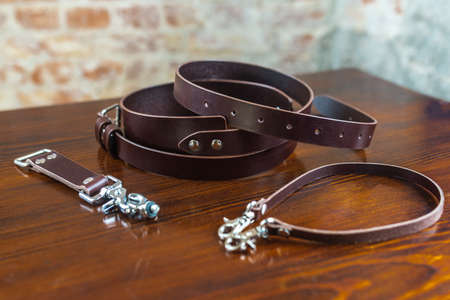 Stylish leather belt on wooden background for mensの写真素材