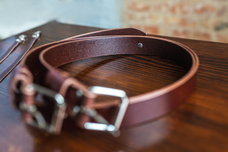 Mens leather trouser belt in the background of aged wood.の写真素材