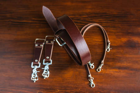 Mens leather trouser belt in the background of aged wood.の写真素材
