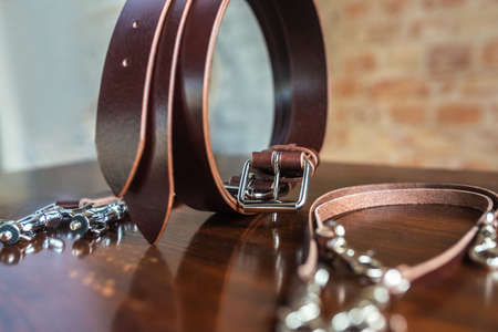 Mens leather trouser belt in the background of wood.の写真素材