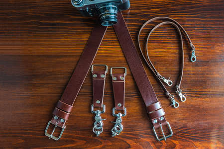 Mens leather trouser belt in the background of wood.の写真素材