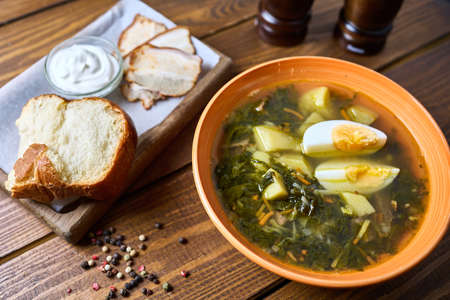 broth with egg and bread with sour creamの写真素材