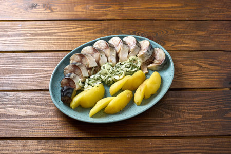 A classic dish of sliced herring served with boiled potatoes and onions, a traditional combination in many European cuisinesの写真素材