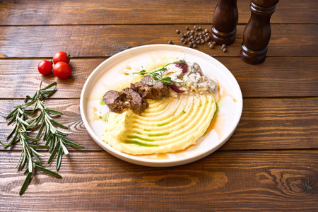 Tender beef served over creamy mashed potatoes with a rich, creamy sauceの写真素材