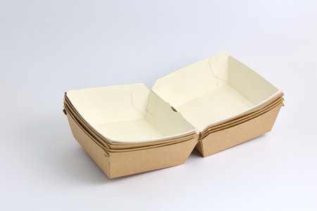 This image showcases two clamshell takeaway containers in contrasting colors