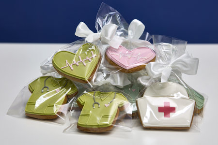 Nurse-themed decorated cookies featuring medical designs such as heartbeats and uniforms in clear...