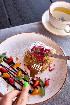 Elegant Dessert with Berries and Tea on Tableの写真素材