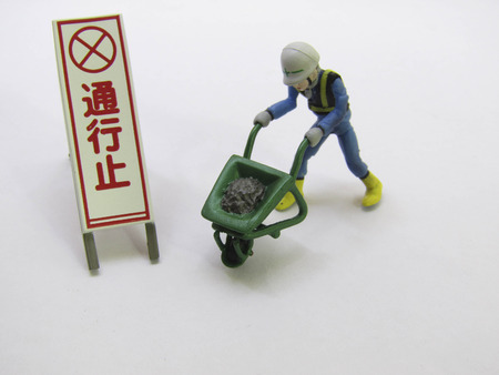 Miniature models are operating with warning signs.の写真素材