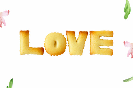The word "LOVE" made from ABC cracker on white backgroundの写真素材