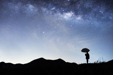 Panorama view of universe space shot of nebula and milky way galaxy with stars on blue night sky . Milky way galaxy with hill under amazing starry night sky. Silhouette of Mountain and skylineの写真素材