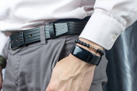 Man using his smart watch app. Close up of hands and fancy luxury watch for men. Businessman with pink shirt suit and wrist watches isolated. Businessman checking time from luxury Watches. Woman. Handの写真素材