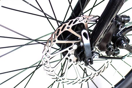 Close up wheel and chain of mountain biking. Landscape view of disc break system and front Derailleur of moutain bike. bicycle parts titanium color and frame aluminium. Shift lever and brake lever.の写真素材