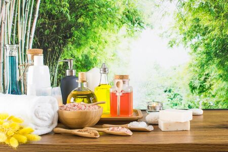 Close up of beauty and fashion concept with spa setting for wellness center. Beautiful composition of spa cosmetic products concept, massage and aromatherapy oil in bamboo forest with light & bokehの写真素材