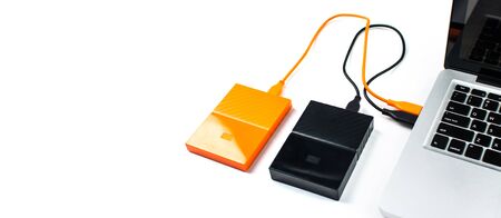 Close up of external hard disk drive for connect to laptop, transfer or backup data between computer and HDD. Black hard disc for backup files and important information using USB 3.0 connectionの写真素材