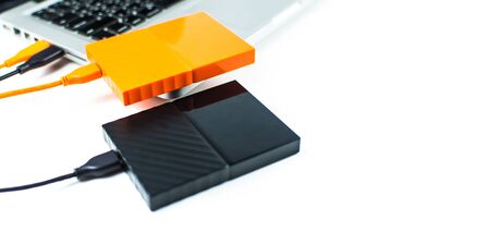 Close up of external hard disk drive for connect to laptop, transfer or backup data between computer and HDD. Black hard disc for backup files and important information using USB 3.0 connectionの写真素材