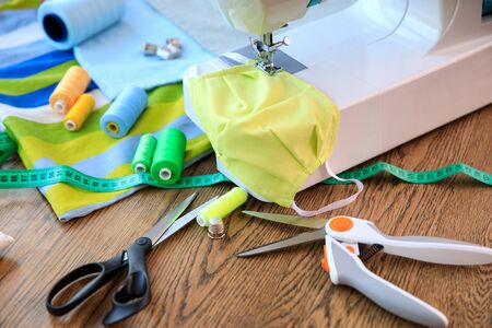 Homemade protection textil face, nose and mouth mask against virus . Sewing protective face masks at...