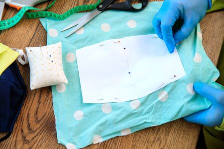 Homemade protection textil face, nose and mouth mask against virus . Sewing protective face masks at...