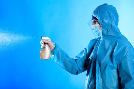 Man wearing protective biological suit and gas-mask due to mers coronavirus global pandemic warning and danger. Medic sphysician scientist make disinfectionの写真素材