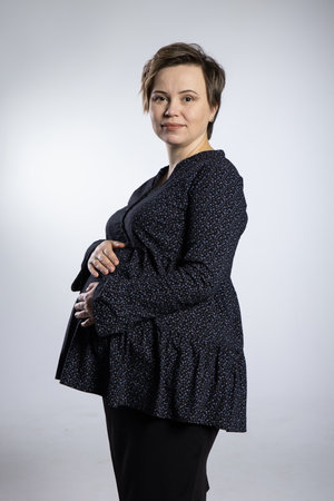Portrait of pregnant woman. Pregnant happy Woman touching her belly, making photo session in studioの写真素材
