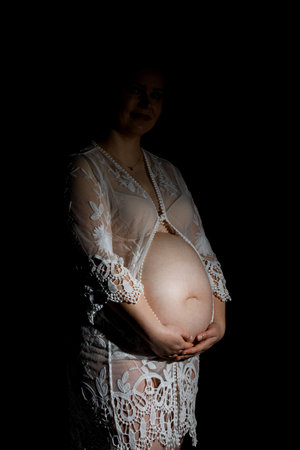Pregnant woman caressing her belly. Pregnant womans bellyの写真素材