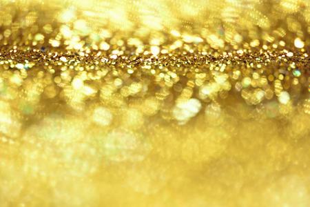 golden glitter texture Colorfull Blurred abstract background for birthday, anniversary, wedding, new year eve or Christmas.の写真素材