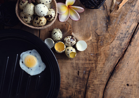 studio shot of quail eggs on a vintage wooden background.