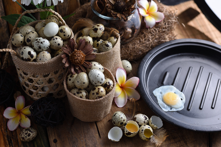 studio shot of quail eggs on a vintage wooden background.の写真素材