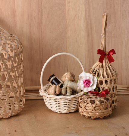 Thai traditional dessert in wicker bamboo basket On wood background.の写真素材