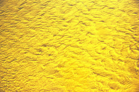 Golden sea wave texture on the beach background.の写真素材