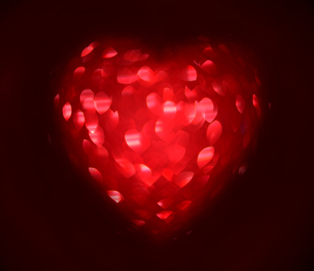 Red Blur heart shape of ligth bokeh on a black background.