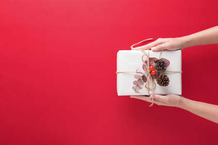 hand holding gift box with Merry Christmas and Happy New Year.