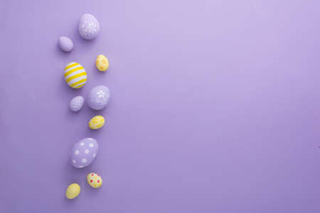 Happy Easter day decoration colorful eggs on paper background with copy space.の写真素材