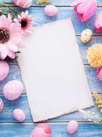 Happy Easter day pink eggs and flower decoration on wood background with copy space.の写真素材