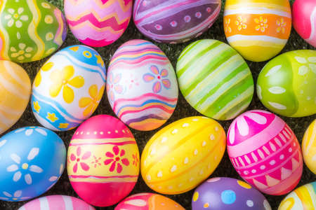 Happy Easter with colorful eggs at paintbrush for do it yourself on the grass with close up from top...