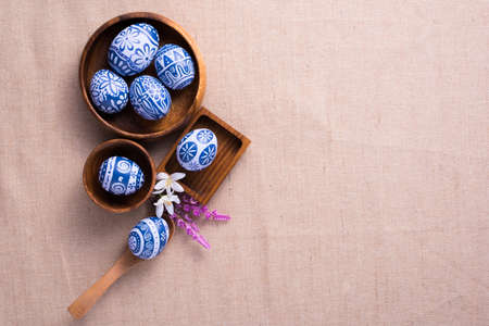 Happy Easter day eggs on brown cloth background with copy space.