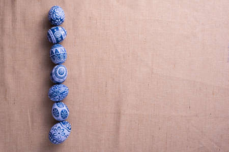 Happy Easter day eggs on brown cloth background with copy space.